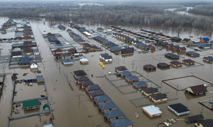 Nearly 12,000 homes are flooded in a Russian region bordering Kazakhstan as water levels keep rising 